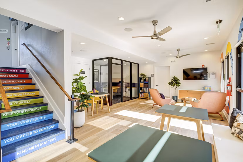 Clubhouse with modern decor and cozy seating at Tuscan Heights Apartments, a luxury community by Greystar