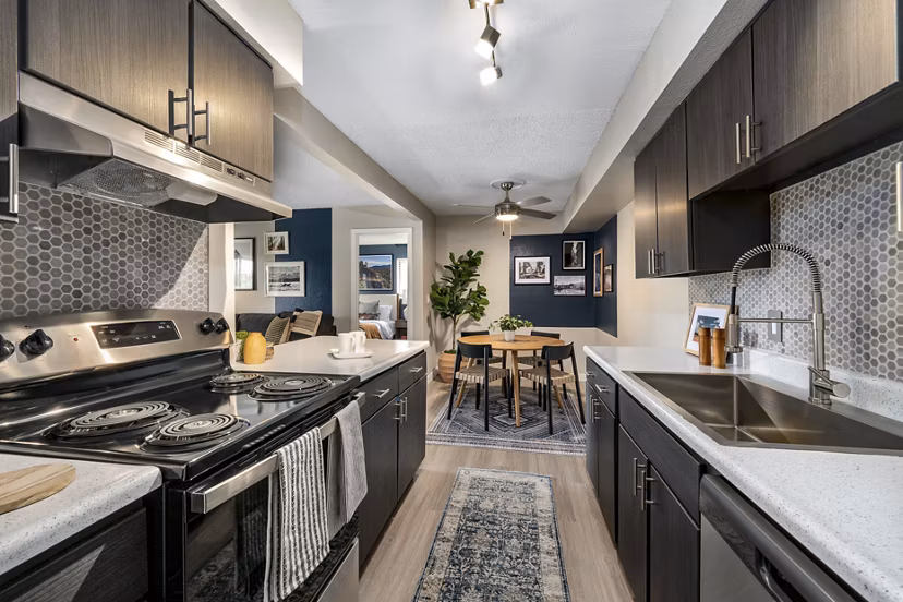 Tuscan Heights Apartments: Modern kitchen with stainless steel appliances and granite countertops