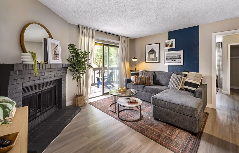 Contemporary living room with plush seating and large windows at Tuscan Heights Apartments