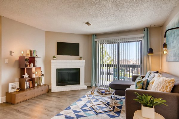 Contemporary living room with plush seating and large windows at Tuscan Heights Apartments