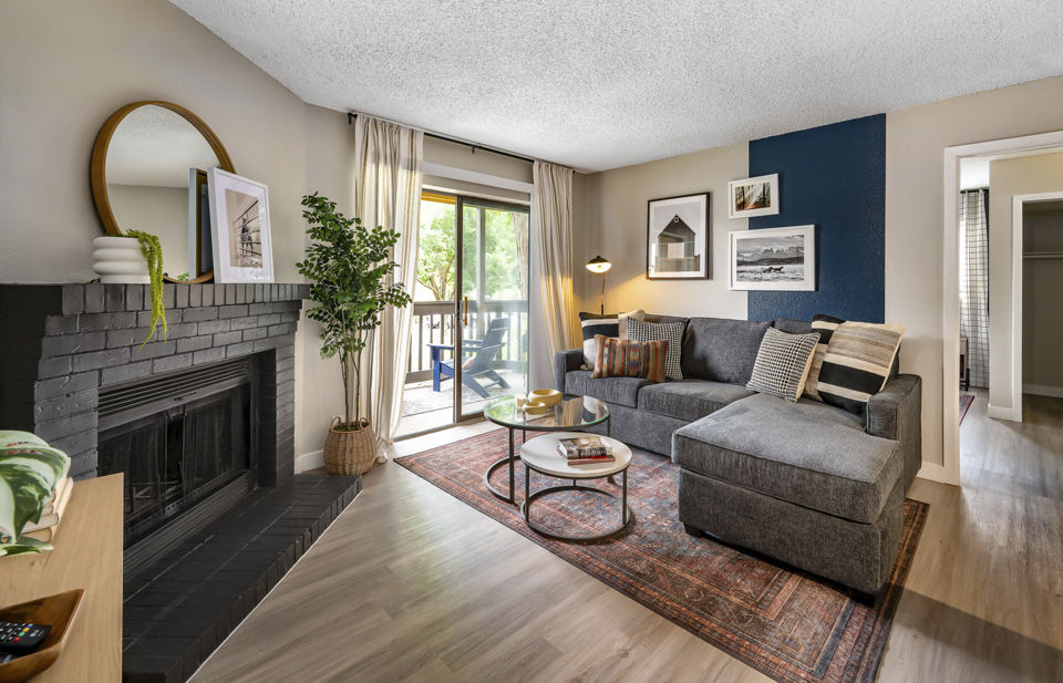 Contemporary living room with plush seating and large windows at Tuscan Heights Apartments