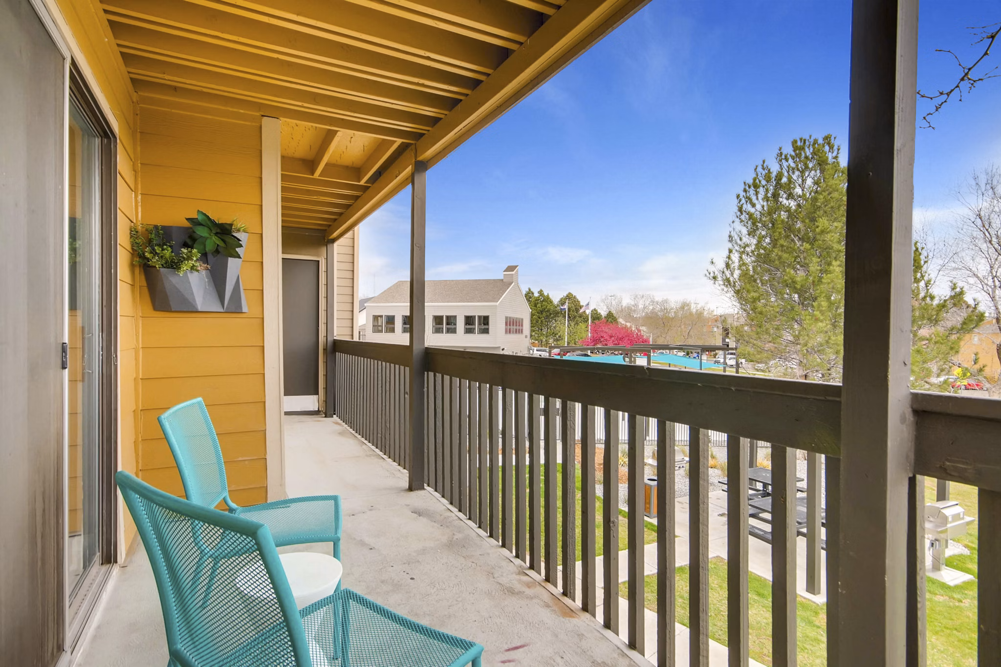 Tuscan Heights Apartments: Cozy patio with scenic views in a serene setting