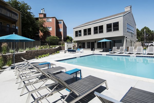 Resort-style pool with palm trees at Tuscan Heights Apartments