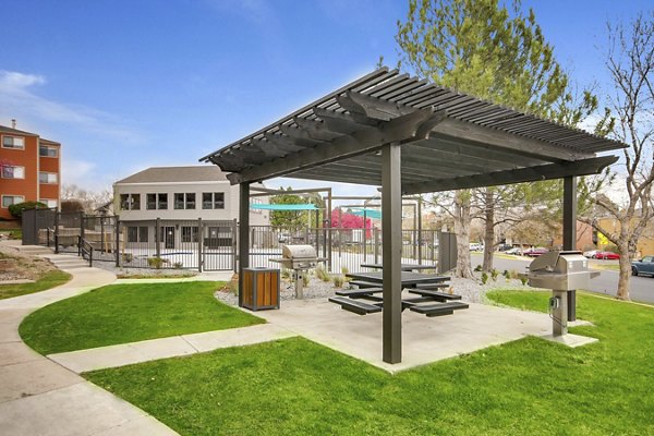 Spacious outdoor grill area with modern seating at Tuscan Heights Apartments, perfect for social gatherings and dining