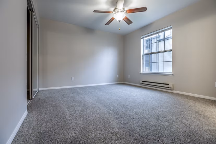 Spacious bedroom featuring modern decor and natural light at Huntington Park Apartments