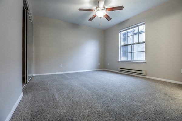 Spacious bedroom featuring modern decor and natural light at Huntington Park Apartments