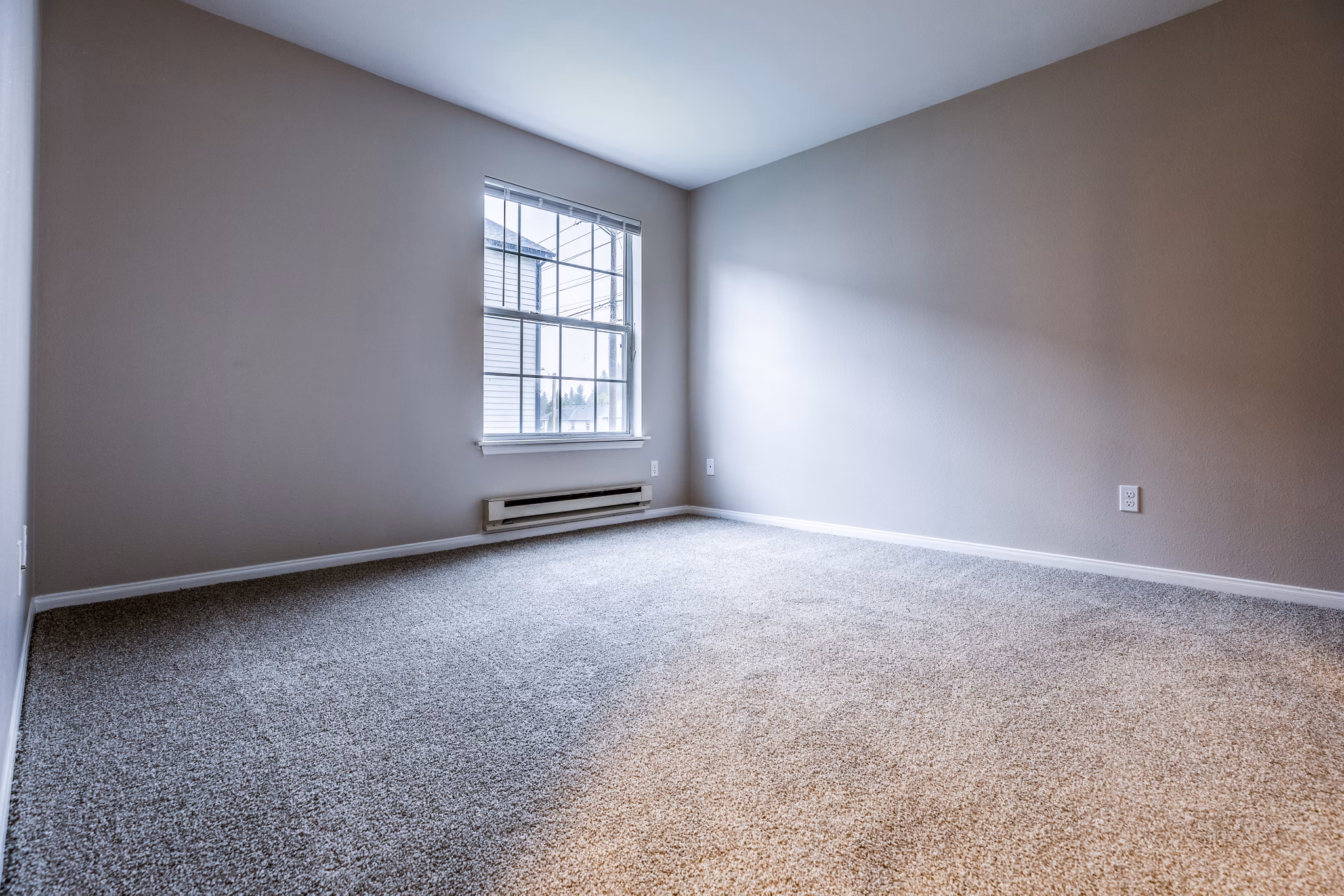 Cozy bedroom with stylish decor in Huntington Park Apartments featuring luxury amenities