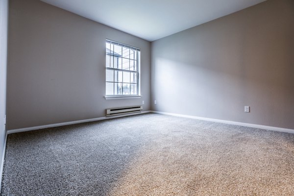 Cozy bedroom with stylish decor in Huntington Park Apartments featuring luxury amenities