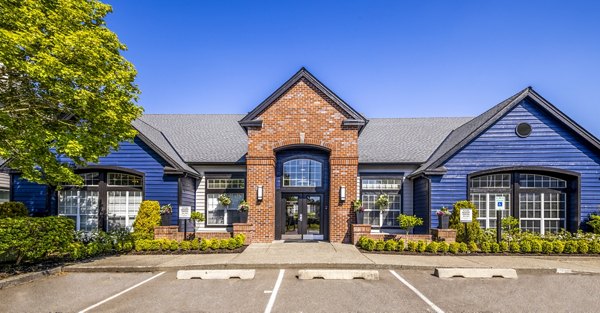 Clubhouse with modern furnishings and large windows at Huntington Park Apartments