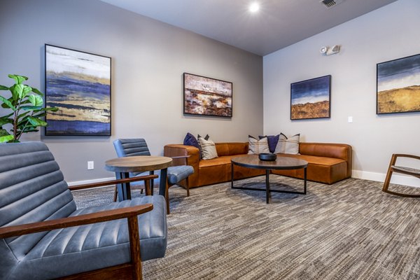 Theater room with plush seating and large screen at Huntington Park Apartments