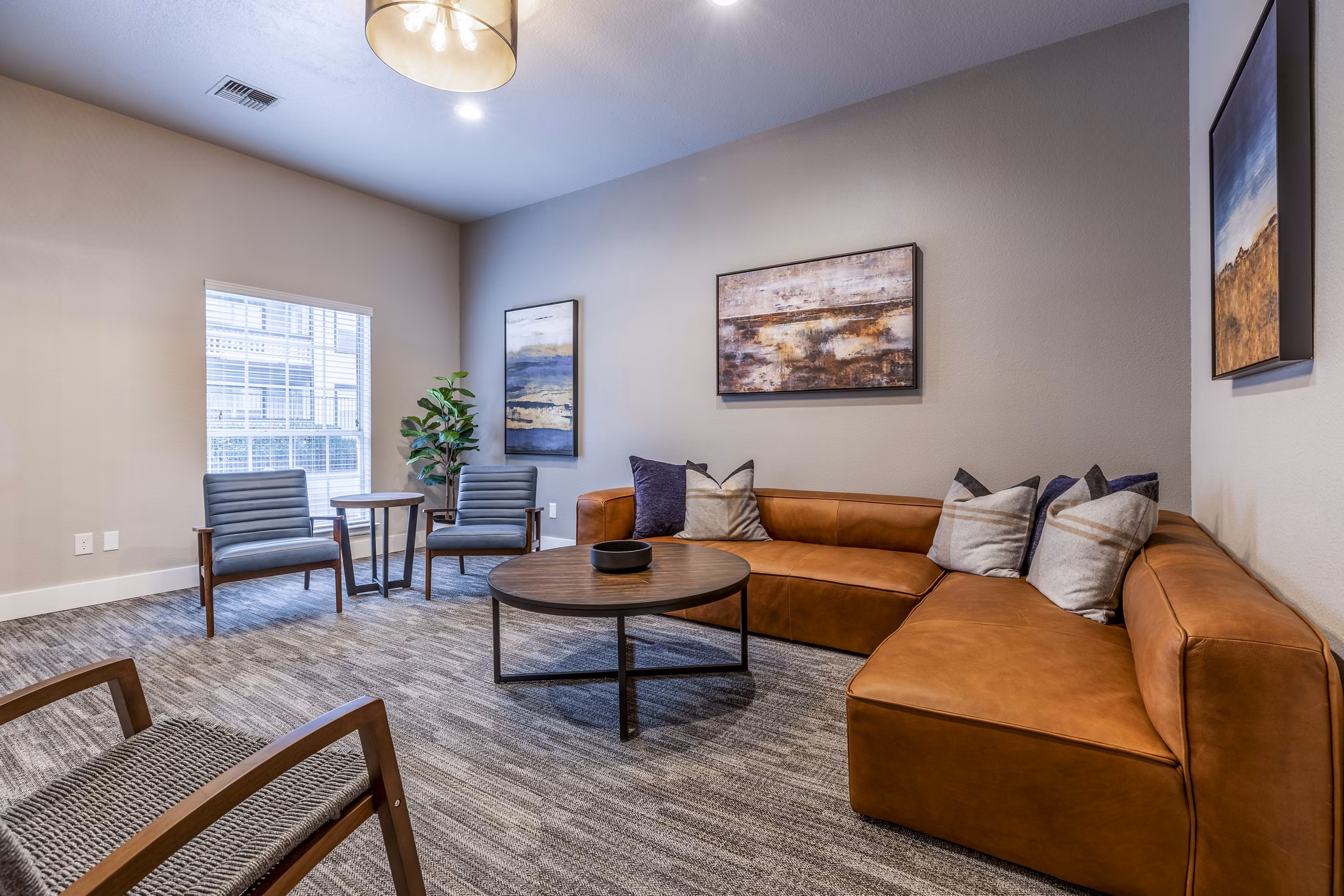 Theater with plush seating and large screen at Huntington Park Apartments