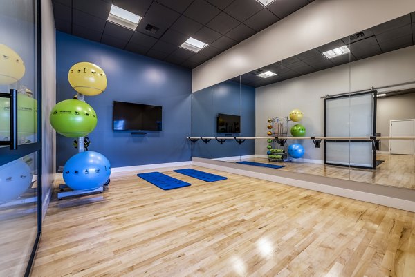 Serene yoga studio with natural light at Huntington Park Apartments for wellness and relaxation