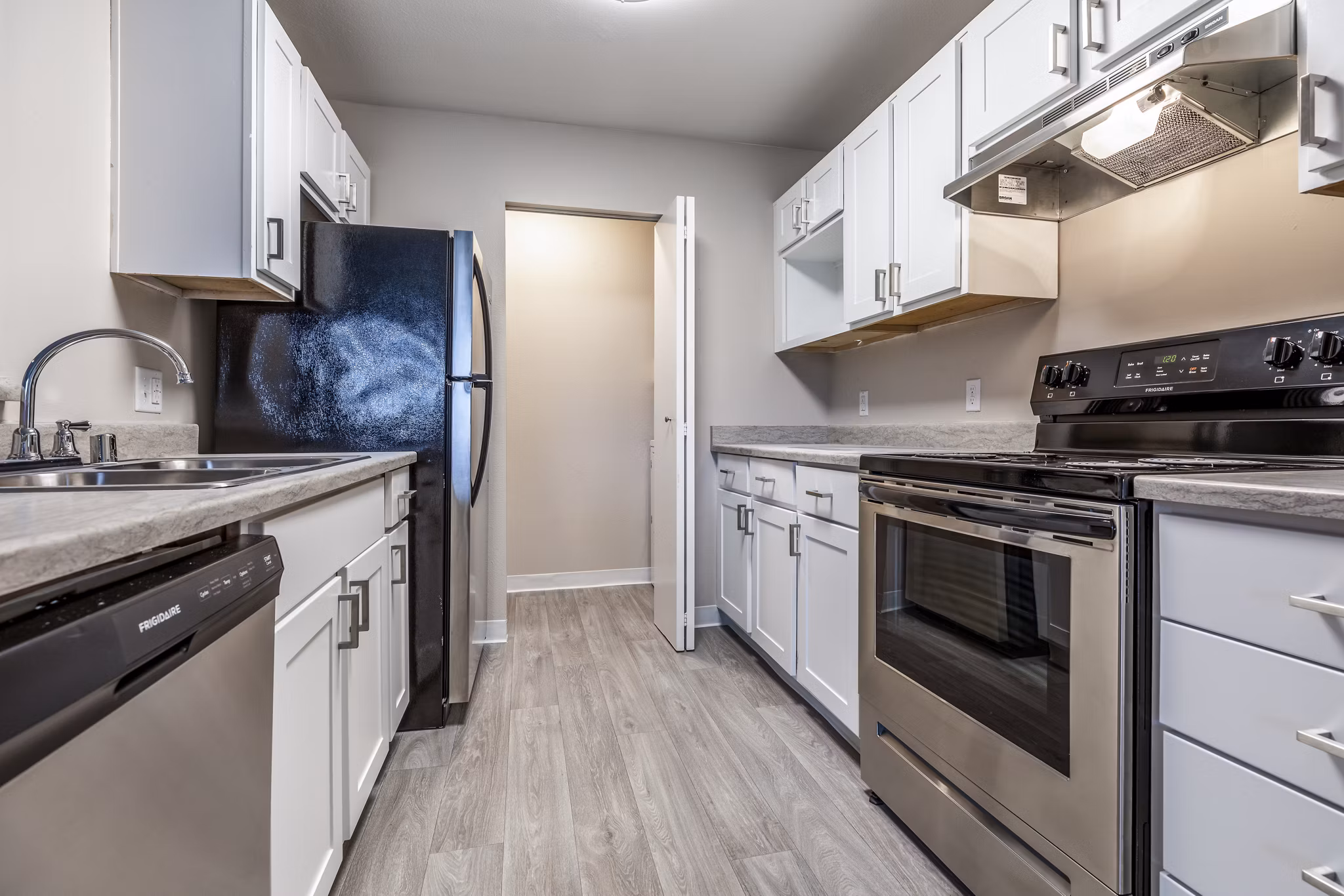 Modern kitchen featuring stainless steel appliances at Huntington Park Apartments