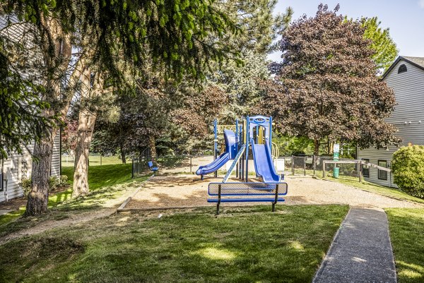 Modern playground with colorful equipment at Huntington Park Apartments