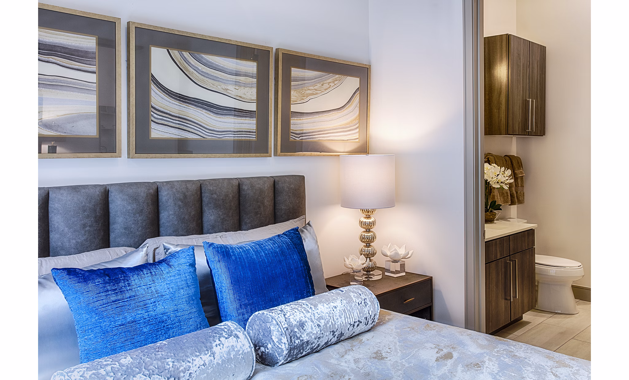 Bedroom with modern decor and ample natural light at Raleigh at Sloans Lake Apartments