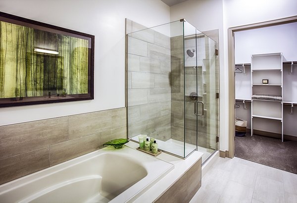 Bathroom with sleek fixtures and elegant tiling in Raleigh at Sloans Lake Apartments