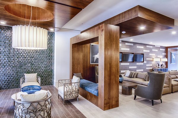 Chic clubhouse lobby with modern seating and lighting at Raleigh at Sloans Lake Apartments