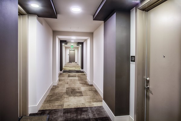 Elegant hallway with contemporary lighting at Raleigh at Sloans Lake Apartments