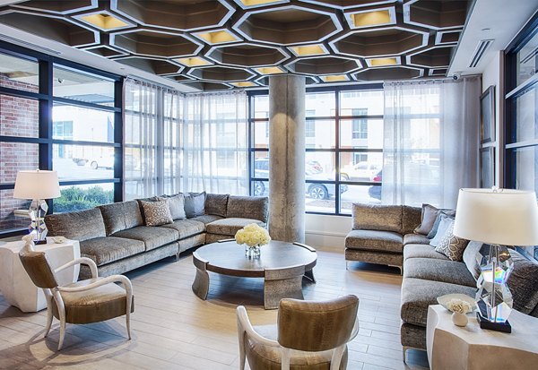 Modern clubhouse and welcoming lobby at Raleigh at Sloans Lake Apartments, featuring stylish seating and open spaces, perfect for social gatherings