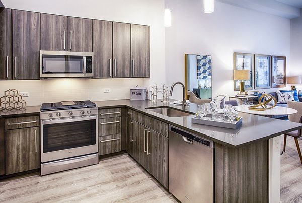 Modern kitchen with stainless steel appliances at Raleigh at Sloans Lake Apartments