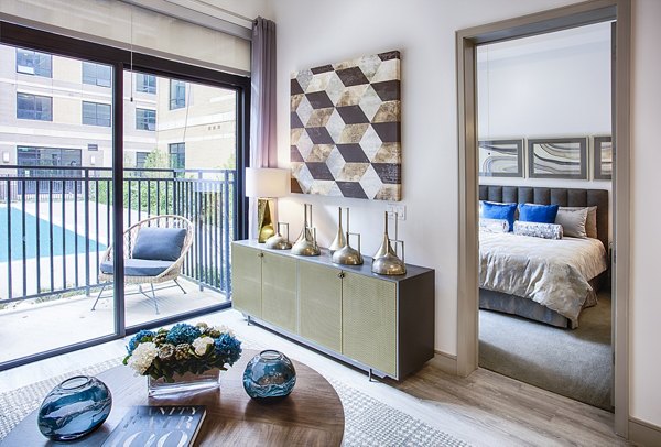 Cozy living room with stylish decor at Raleigh at Sloans Lake Apartments, offering comfort and elegance in a luxury Greystar property