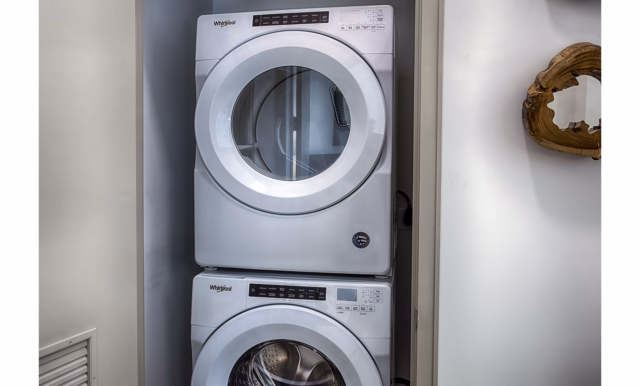 Laundry room with modern appliances at Raleigh at Sloans Lake Apartments, featuring energy-efficient washers and dryers