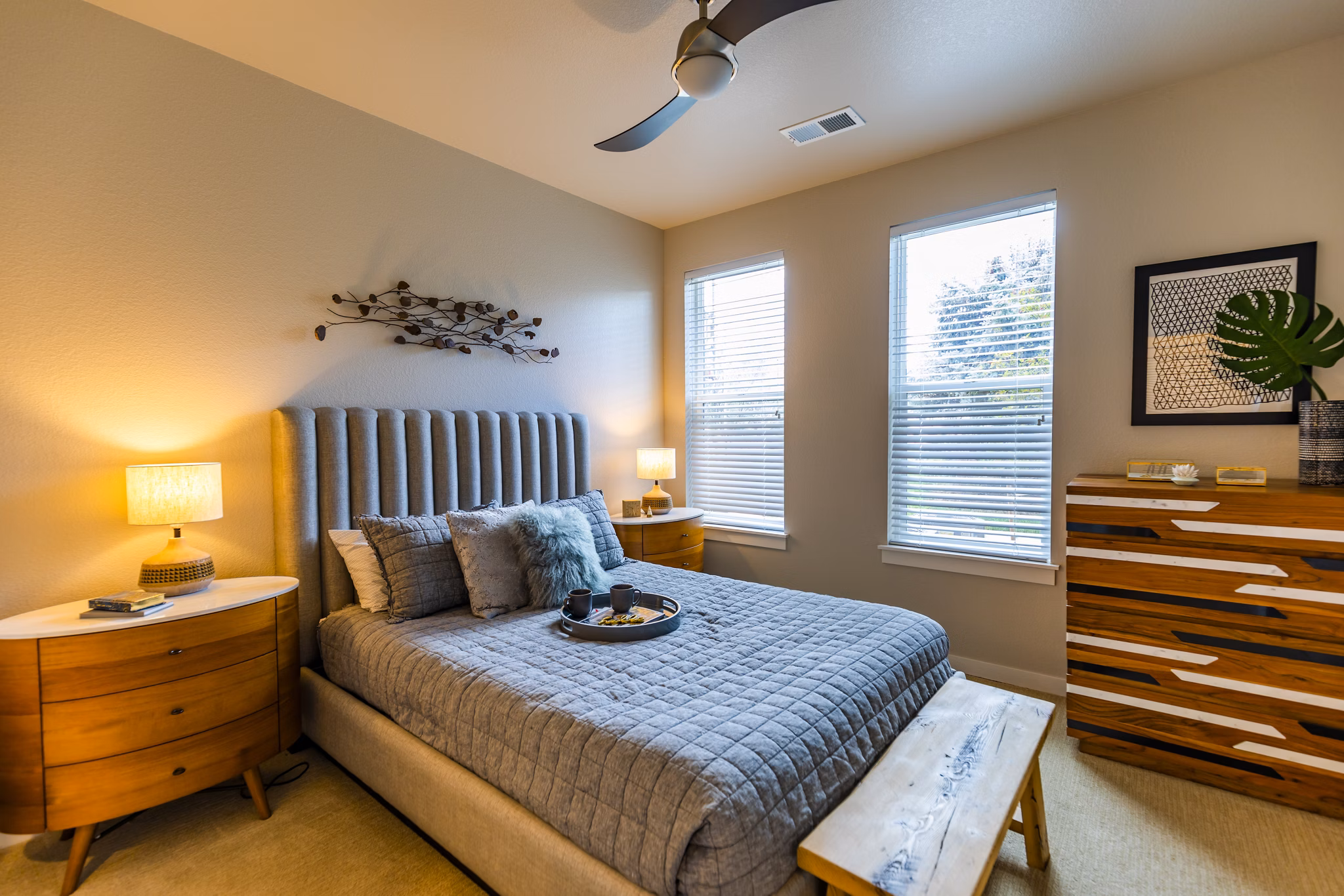 The Tenzing Apartments: Cozy bedroom with stylish decor and natural light