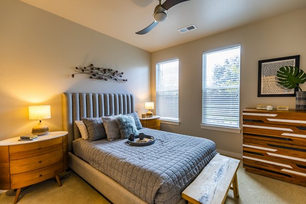 The Tenzing Apartments: Cozy bedroom with stylish decor and natural light
