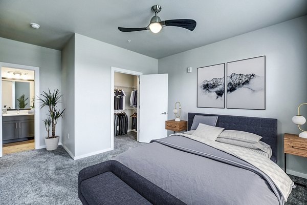 Bedroom featuring modern decor and city views at The Tenzing Apartments Enjoy luxurious living in Greystar's premium apartment community