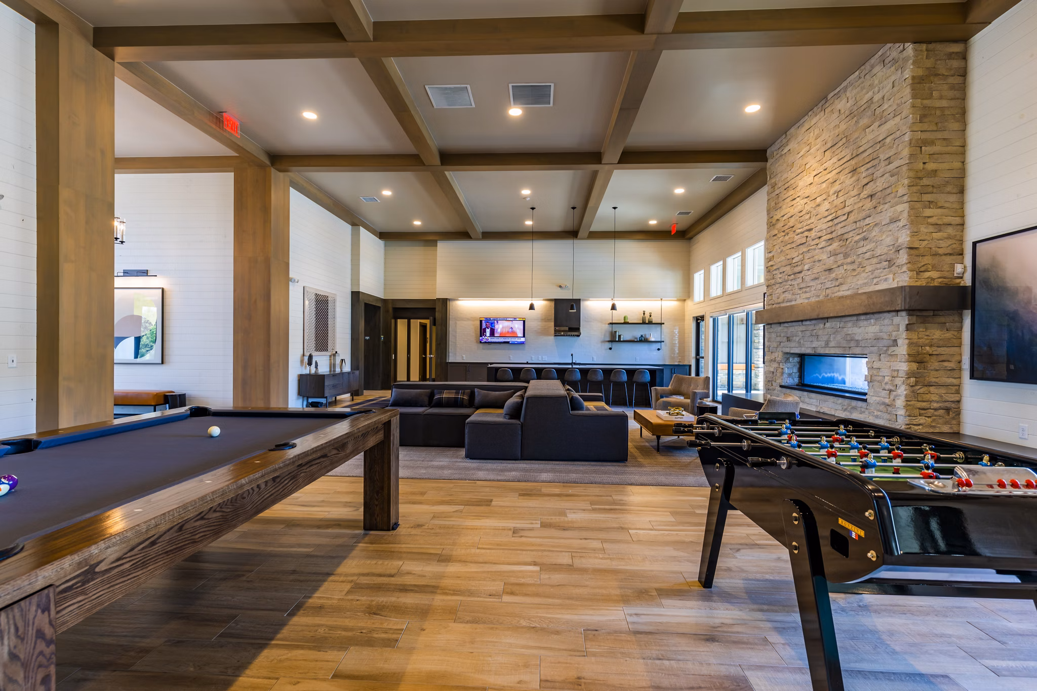 Game room with pool table and arcade games at The Tenzing Apartments