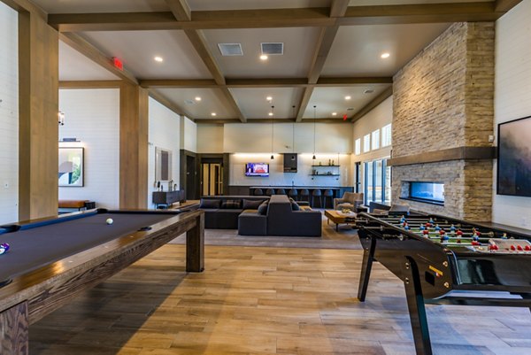 Game room with pool table and arcade games at The Tenzing Apartments