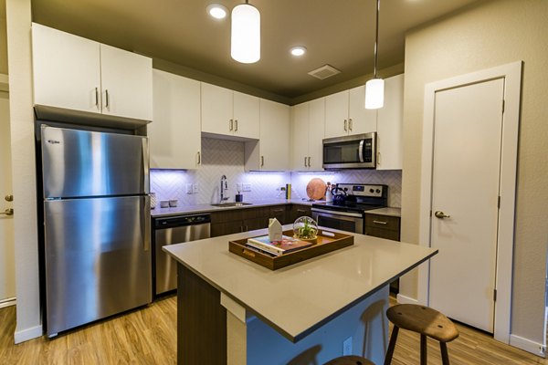 Modern kitchen with stainless steel appliances at The Tenzing Apartments
