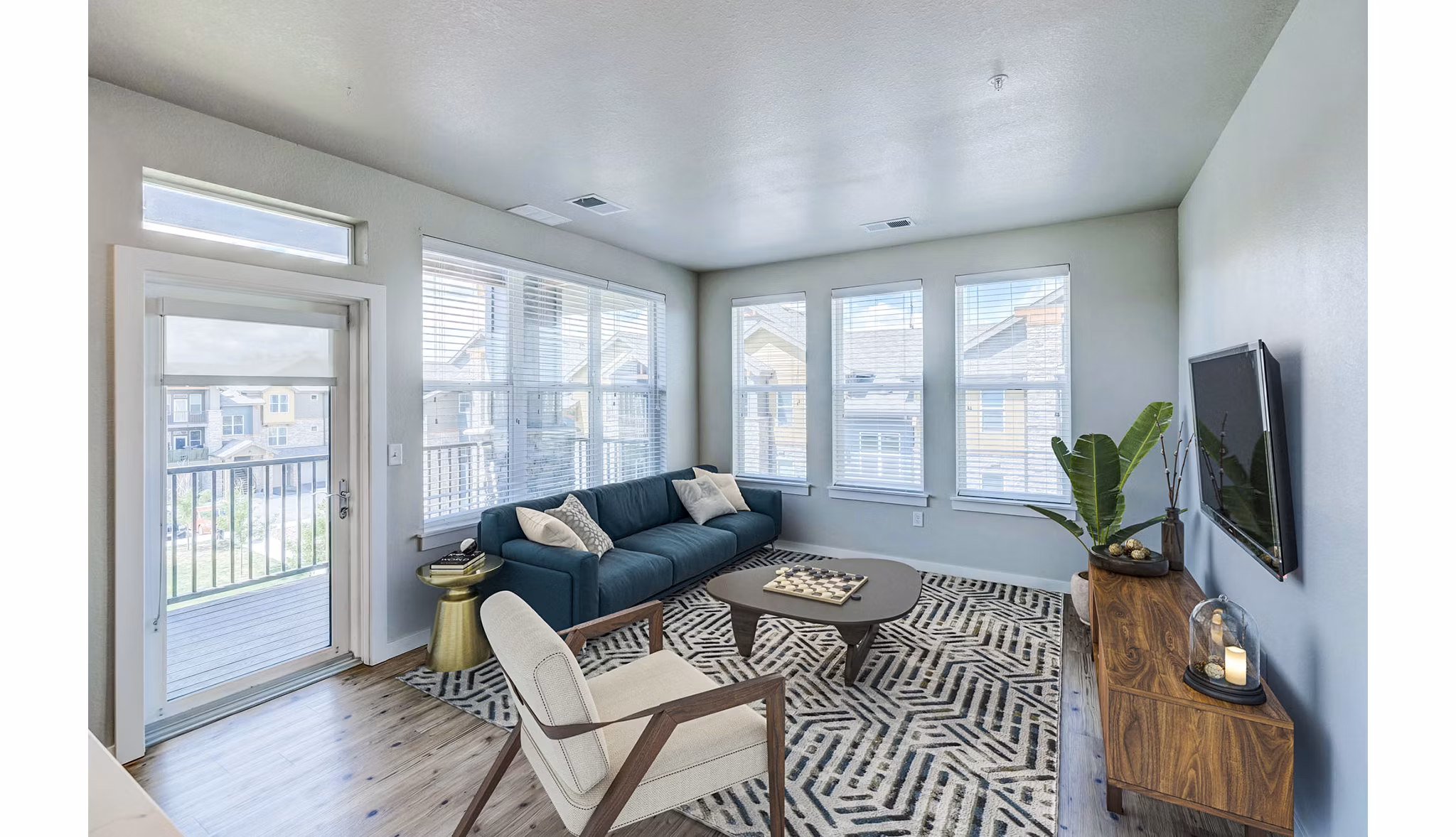 Spacious living room with modern decor in The Tenzing Apartments
