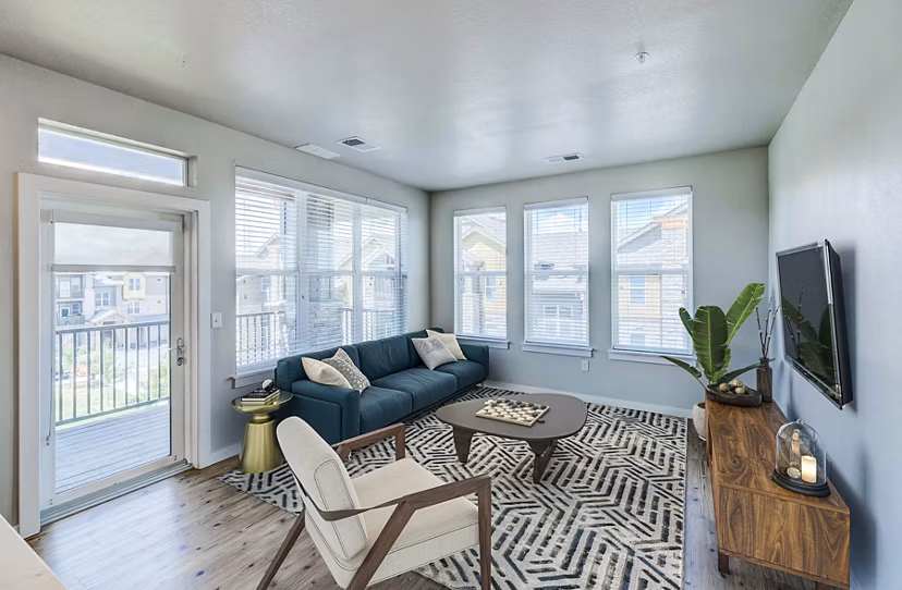 Spacious living room with modern decor in The Tenzing Apartments