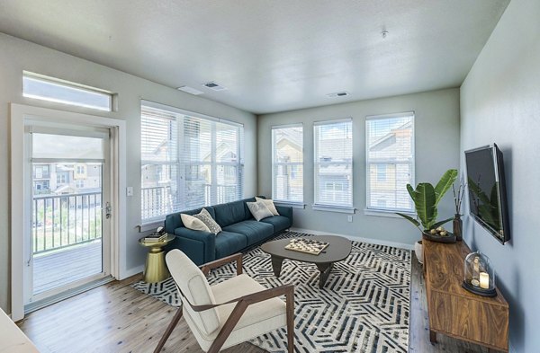 Spacious living room with modern decor in The Tenzing Apartments