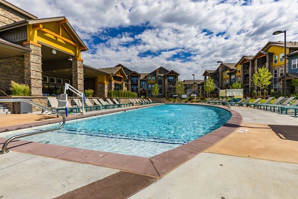 Modern pool area with lounge chairs at The Tenzing Apartments luxury community