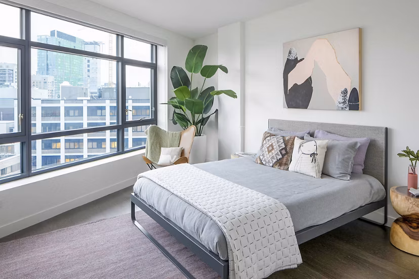 Contemporary bedroom featuring sleek design and large windows in Bower Apartments, offering luxury living in a Greystar community