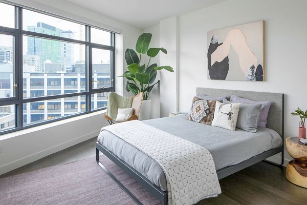 Contemporary bedroom featuring sleek design and large windows in Bower Apartments, offering luxury living in a Greystar community