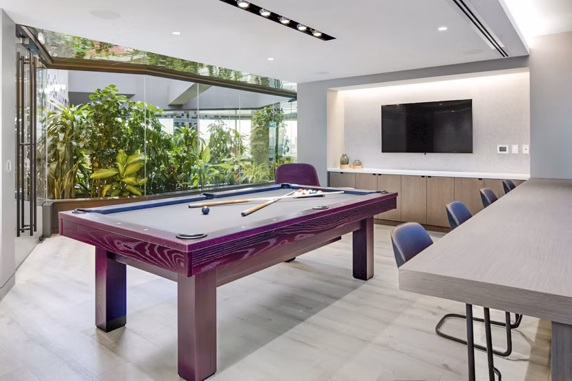 Game room featuring billiards and arcade games at Bower Apartments