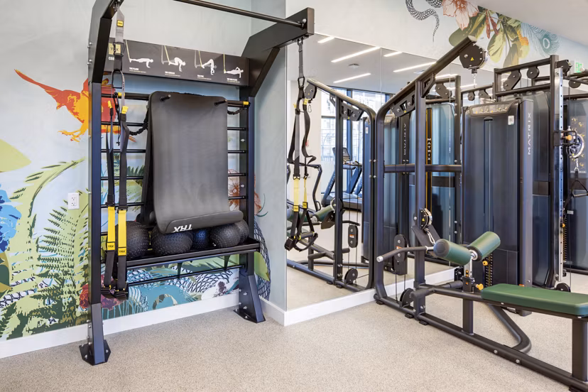 Fully-equipped fitness center at Bower Apartments, featuring modern workout machines and a spacious layout for a luxury workout experience