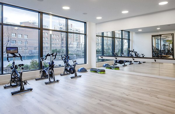 Fitness studio at Bower Apartments featuring yoga and spin classes with modern equipment for an active lifestyle
