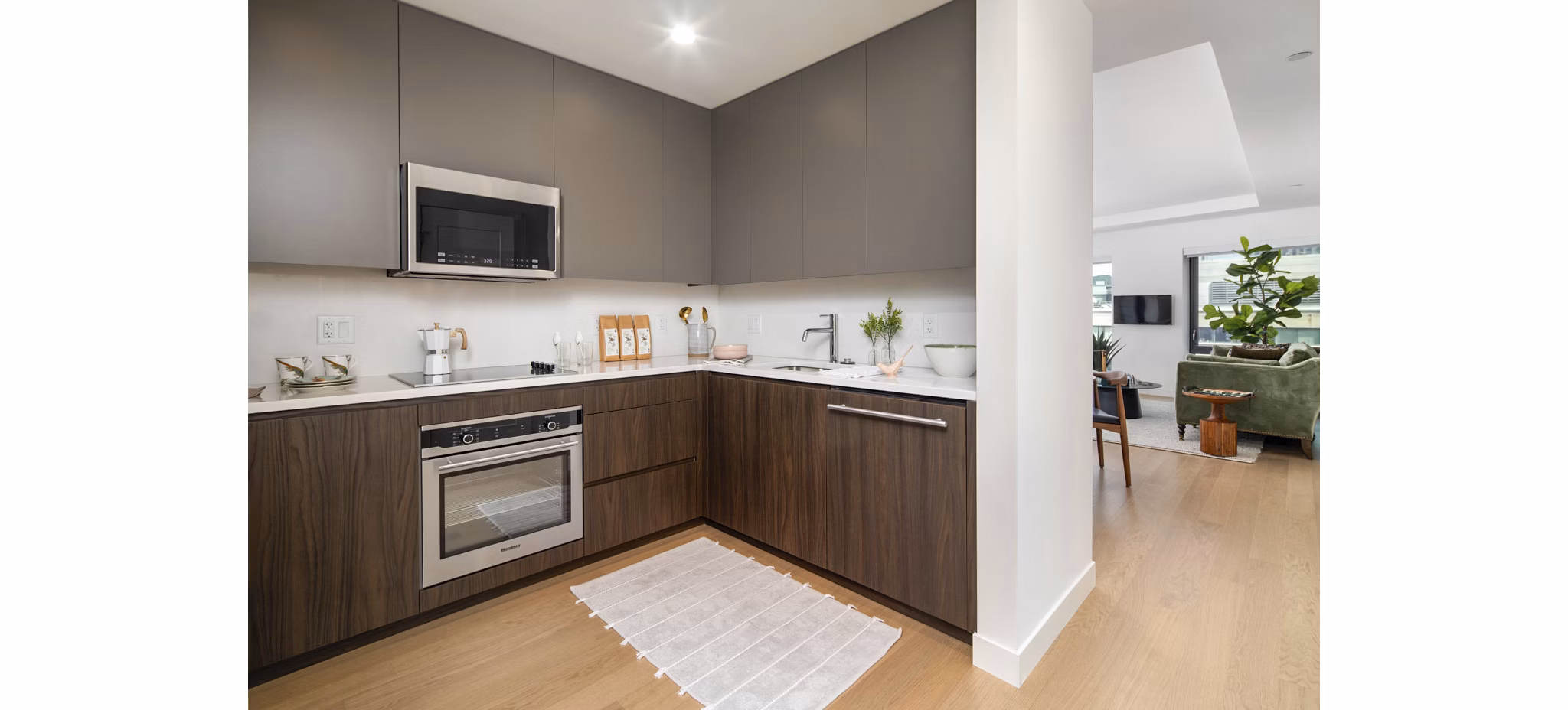 Modern kitchen featuring sleek countertops and stainless steel appliances in Bower Apartments
