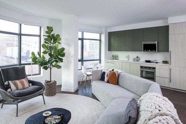 Modern living room with sleek furniture and large windows at Bower Apartments in luxury Greystar community