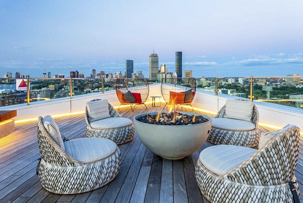 Fire pit on outdoor patio at Bower Apartments, featuring cozy seating and modern design, perfect for social gatherings and relaxation time
