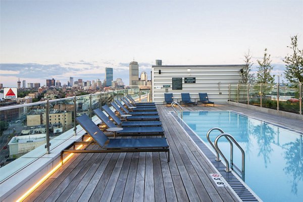 Luxurious pool with sun loungers at Bower Apartments, perfect for relaxation in a serene setting