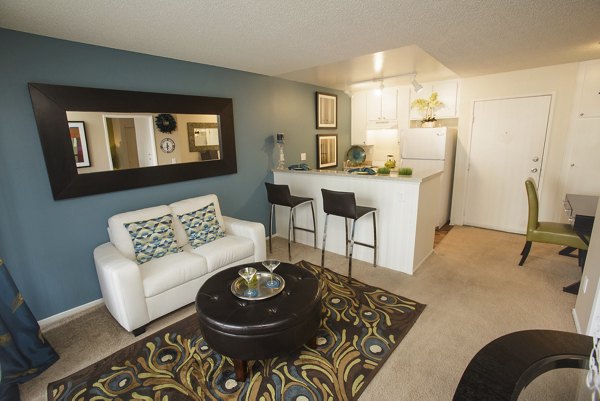 Modern living room with sleek furniture in 777 Place Apartments, featuring contemporary design and ample natural light