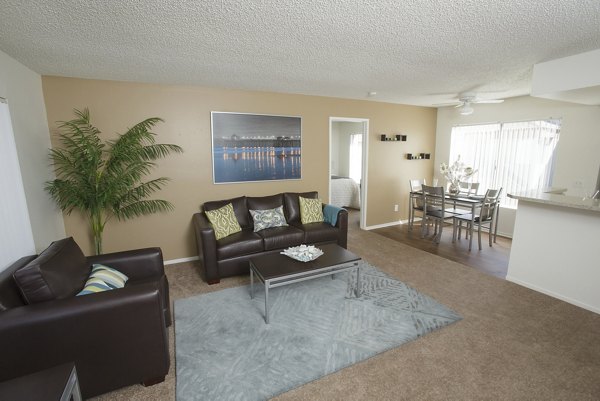 Living room with modern decor and ample natural light at 777 Place Apartments, a Greystar luxury apartment community