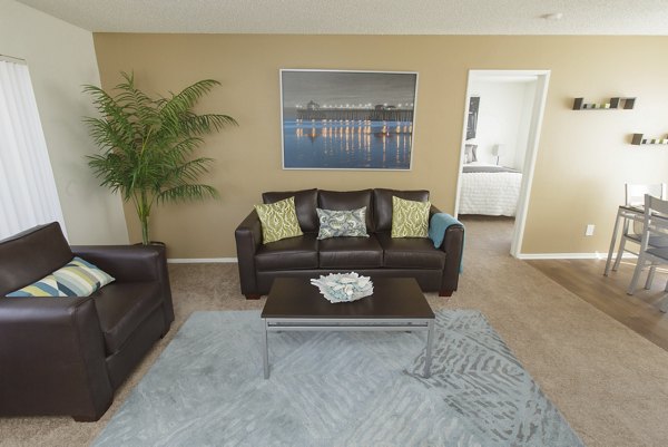 Spacious living area with modern furnishings at 777 Place Apartments