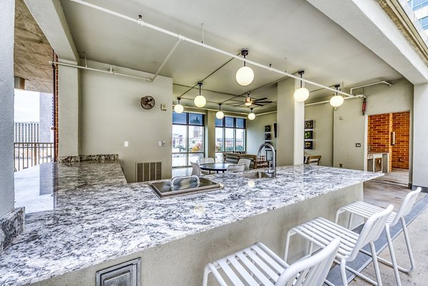 Outdoor patio bar with seating area at Inspire Downtown Apartments' clubhouse