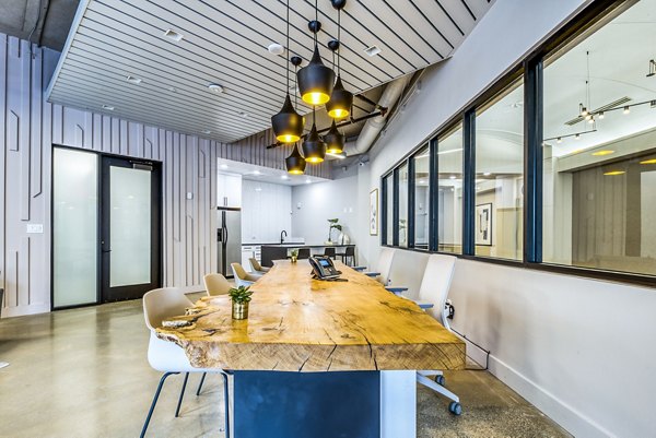 Inspire Downtown Apartments: Modern clubhouse/meeting room with sleek furnishings and ample seating areas
